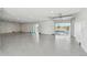 Spacious garage with epoxy floor, recessed lighting, and a sliding door leading to the outdoor pool and canal at 2832 W Vina Del Mar Blvd, St Pete Beach, FL 33706