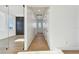 Light-filled hallway showcasing wood floors and minimalist white walls at 2832 W Vina Del Mar Blvd, St Pete Beach, FL 33706