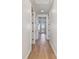 Bright hallway featuring hardwood floors, white walls, and recessed lighting leading to the outdoor space at 2832 W Vina Del Mar Blvd, St Pete Beach, FL 33706