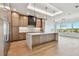 Modern kitchen featuring a large center island, wooden cabinets, and stainless appliances at 2832 W Vina Del Mar Blvd, St Pete Beach, FL 33706