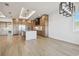 Open-concept kitchen with a large island, stainless steel appliances, and hardwood floors at 2832 W Vina Del Mar Blvd, St Pete Beach, FL 33706
