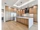 Modern kitchen featuring a large center island, wooden cabinets, and stainless appliances at 2832 W Vina Del Mar Blvd, St Pete Beach, FL 33706