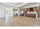 Open-concept kitchen featuring a large island, stainless steel appliances, and custom wood cabinetry at 2832 W Vina Del Mar Blvd, St Pete Beach, FL 33706