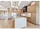 Gourmet kitchen with a large waterfall island, designer lighting, and modern appliances at 2832 W Vina Del Mar Blvd, St Pete Beach, FL 33706