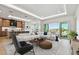 Open-concept living area with stylish decor, modern furniture, and water views at 2832 W Vina Del Mar Blvd, St Pete Beach, FL 33706