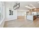 Expansive living area with hardwood floors and an open floorplan that connects the kitchen and dining at 2832 W Vina Del Mar Blvd, St Pete Beach, FL 33706