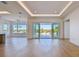 Bright living room with floor-to-ceiling windows and access to a waterfront balcony at 2832 W Vina Del Mar Blvd, St Pete Beach, FL 33706