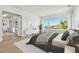 A well-lit main bedroom suite features a window view, elegant furniture and an open plan at 2832 W Vina Del Mar Blvd, St Pete Beach, FL 33706