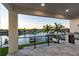 Covered outdoor patio featuring a waterfront view, kitchen, and stainless steel appliances at 2832 W Vina Del Mar Blvd, St Pete Beach, FL 33706