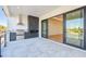 Spacious outdoor terrace featuring a built-in grill, fireplace, and sliding glass doors at 2832 W Vina Del Mar Blvd, St Pete Beach, FL 33706