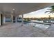 Stunning outdoor living space with a covered patio, pool, and waterfront views, perfect for entertaining and relaxation at 2832 W Vina Del Mar Blvd, St Pete Beach, FL 33706