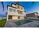 Modern home backyard featuring a sparkling pool and sleek staircase at 2832 W Vina Del Mar Blvd, St Pete Beach, FL 33706