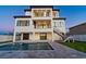 Contemporary two-story home with a private pool, covered patio, and outdoor staircase overlooking the backyard at 2832 W Vina Del Mar Blvd, St Pete Beach, FL 33706