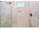 Modern shower with stylish marble tiles, sleek glass divider, and minimalist fixtures offers a luxurious bathing experience at 2832 W Vina Del Mar Blvd, St Pete Beach, FL 33706
