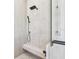 Close-up of shower featuring dual shower heads, glass door and tile surround at 2832 W Vina Del Mar Blvd, St Pete Beach, FL 33706
