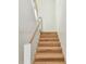 Elegant wood staircase with minimalist white and black railing at 2832 W Vina Del Mar Blvd, St Pete Beach, FL 33706