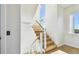 Modern staircase with wood treads, cable railing, and large window at 2832 W Vina Del Mar Blvd, St Pete Beach, FL 33706