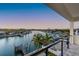 Serene waterfront view from the balcony, with palm trees and boats dotting the canal for picturesque scenery at 2832 W Vina Del Mar Blvd, St Pete Beach, FL 33706