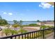 Balcony view showcasing beautifully landscaped grounds, waterfront views and blue skies for a peaceful and luxurious atmosphere at 8 Belleview Blvd # 203, Belleair, FL 33756
