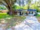 Brick ranch home with mature tree and driveway at 207 Orange Dr, Lutz, FL 33548