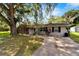 Single story home with a spacious yard and driveway at 207 Orange Dr, Lutz, FL 33548