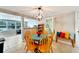 Bright dining area with wood table and chairs, offering a view into the kitchen and living room at 207 Orange Dr, Lutz, FL 33548