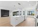 Open floor plan with kitchen island, living room fireplace, and water views at 1810 4Th E St, Palmetto, FL 34221