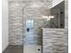 Walk-in shower with gray stone tile and glass enclosure at 1810 4Th E St, Palmetto, FL 34221