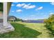 Spacious backyard with water view, grassy lawn, and paver patio at 1810 4Th E St, Palmetto, FL 34221