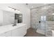 Modern bathroom with white cabinets, quartz countertop, and walk-in shower at 1810 4Th E St, Palmetto, FL 34221
