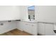 Clean laundry room with white cabinets and a built-in countertop at 1810 4Th E St, Palmetto, FL 34221