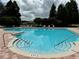 Community pool with ample deck space for lounging at 32425 Fish Hook Loop, Wesley Chapel, FL 33545