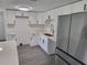 Modern kitchen with white cabinets and stainless steel appliances at 12800 Vassar Ct, Hudson, FL 34667