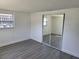 Spacious bedroom with mirrored closet doors and gray flooring at 12800 Vassar Ct, Hudson, FL 34667