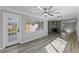 Bright living room featuring wood-look floors and sliding glass doors leading to backyard at 4300 16Th N Ave, St Petersburg, FL 33713