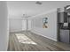 Living room with wood-look floors, window, and kitchen view at 4300 16Th N Ave, St Petersburg, FL 33713