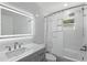 Modern bathroom with LED mirror and white tile at 4300 16Th N Ave, St Petersburg, FL 33713