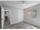 Bedroom with wood-look floors, a closet, and hallway view at 4300 16Th N Ave, St Petersburg, FL 33713