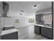Modern kitchen with gray cabinets, marble countertops, and stainless steel appliances at 4300 16Th N Ave, St Petersburg, FL 33713