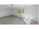 Light-filled living room with wood-look floors and window view at 4300 16Th N Ave, St Petersburg, FL 33713