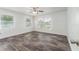 Bright bedroom with wood-look floors, large windows, and a ceiling fan at 701 17Th S Ave, St Petersburg, FL 33701