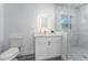 Bright bathroom with white vanity, a walk-in shower, and gray hexagon floor tile at 701 17Th S Ave, St Petersburg, FL 33701
