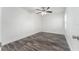 Simple bedroom with wood-look floors, ceiling fan, and neutral walls at 701 17Th S Ave, St Petersburg, FL 33701