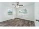 Spacious bedroom with two windows, ceiling fan, and laminate flooring at 701 17Th S Ave, St Petersburg, FL 33701