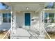 Inviting front porch with ornate railings and a teal front door at 701 17Th S Ave, St Petersburg, FL 33701