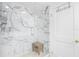 Spacious walk-in shower with marble tile and glass enclosure at 8 Belleview Blvd # 203, Belleair, FL 33756