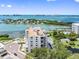 Aerial view of waterfront condo building with water access and parking at 8 Belleview Blvd # 203, Belleair, FL 33756