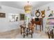 Open concept dining area with a unique chandelier and kitchen view at 8 Belleview Blvd # 203, Belleair, FL 33756