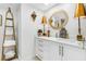 Elegant bathroom with white cabinets, a large mirror, and gold accents at 8 Belleview Blvd # 203, Belleair, FL 33756