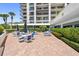 Spacious patio with seating and umbrellas for relaxation at 8 Belleview Blvd # 203, Belleair, FL 33756